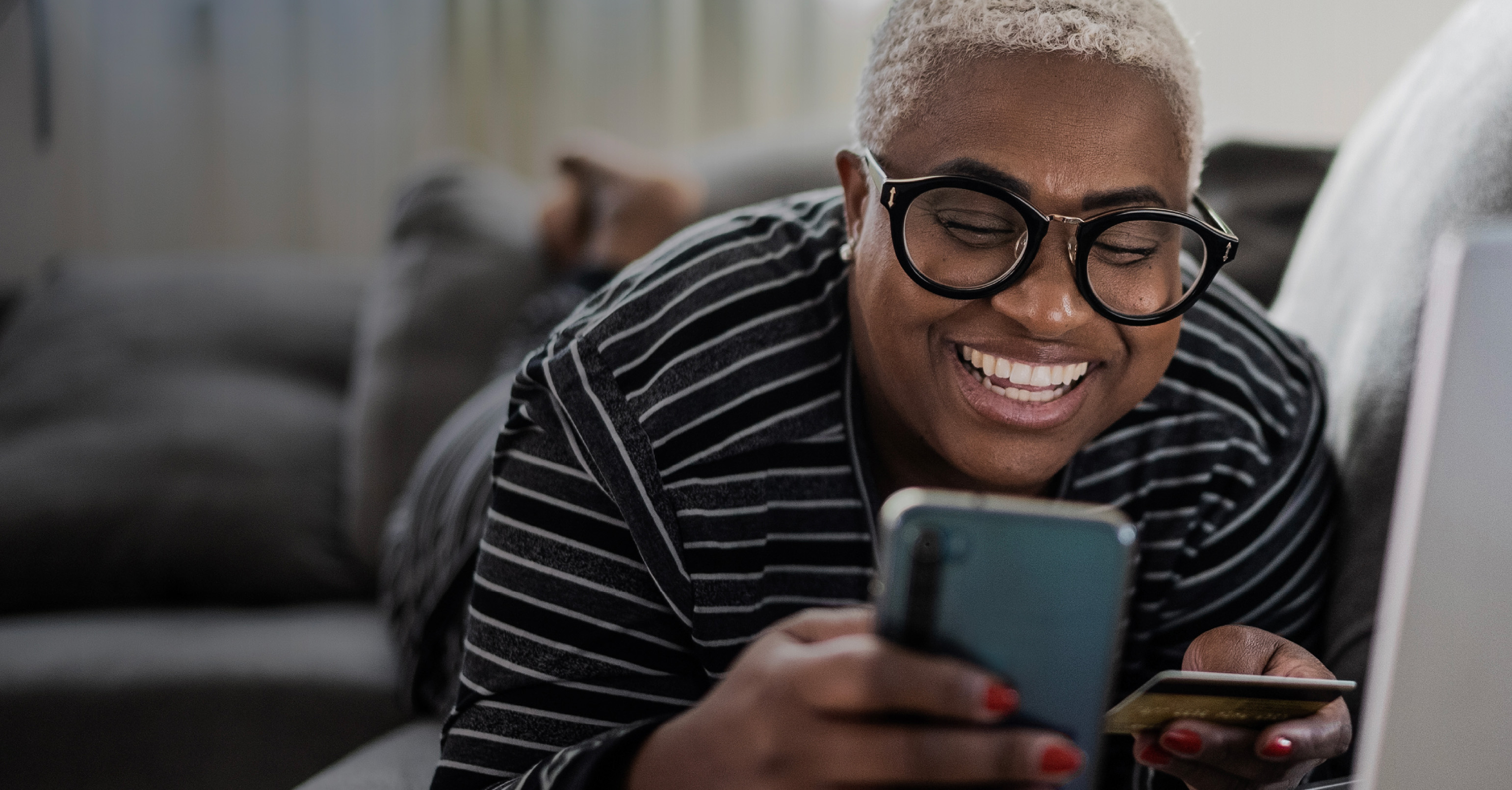 Woman smiling while viewing mobile phone